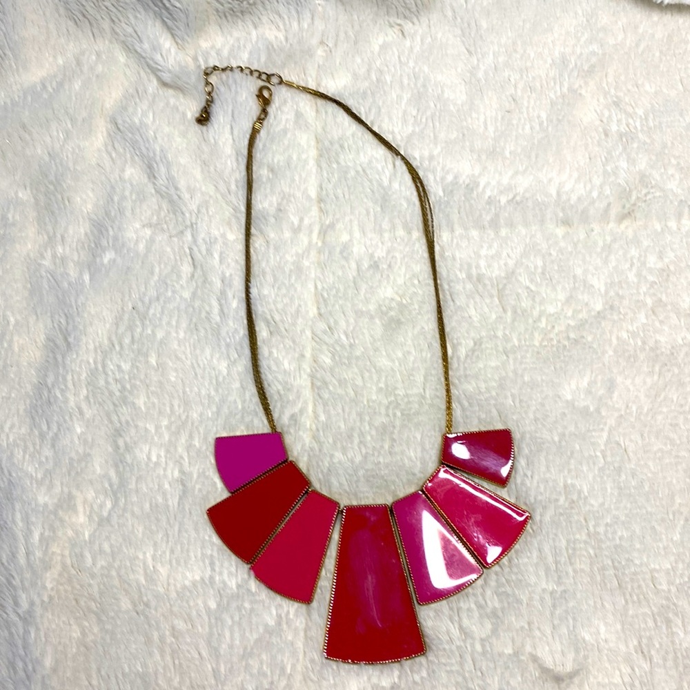 Bright pink and gold necklace.